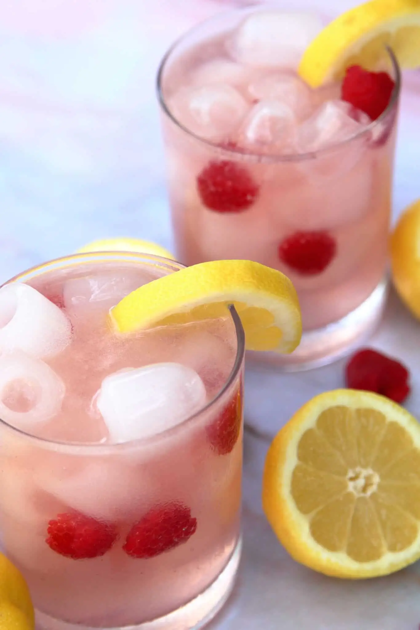 Two Cocktailglasses filled with Raspberry Lemonade Vodka Spritzer.